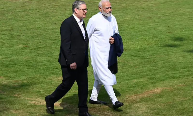 British Prime Minister Sir Keir Starmer and Indian Prime Minister Narendra Modi walk through the gardens at Raj Bhavan on October 9 in Mumbai, India. &mdash; Reuters