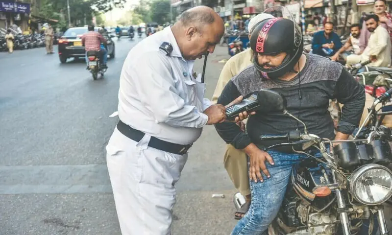 In this file photo, a motorcyclist is caught by a sergeant over wrong-way violation.
&mdash;Fahim Siddiqi / White Star/File
