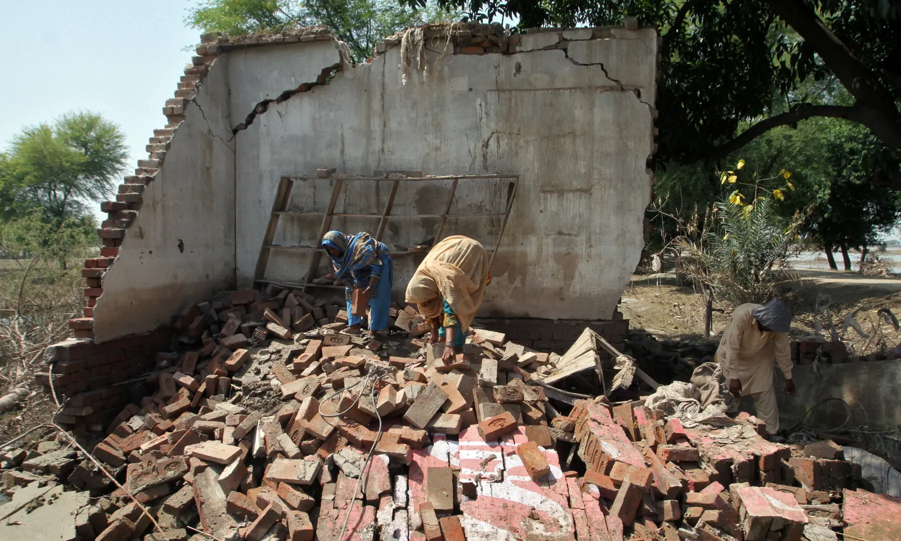Residents work at a damaged property, following monsoon rains and flooding, in Kabirwala on September 17, 2025. — Reuters