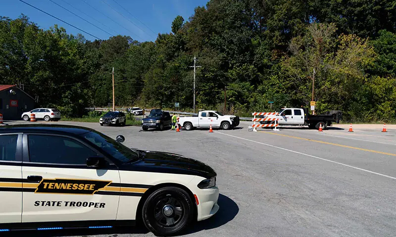 Police and Department of Transportation workers block the road leading to the Accurate Energetic Systems explosives plant following an explosion on October 10. &mdash; AFP