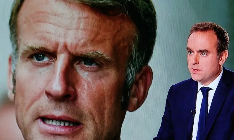 This photograph shows a television screen displaying France&rsquo;s outgoing Prime Minister Sebastien Lecornu (R), with an image of France&rsquo;s President Emmanuel Macron in the background. &mdash; AFP