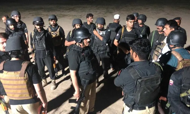 Police forces stand outside the police training center after it came under attack on Friday in Dera Ismail Khan. — Photo provided by Umar Bacha