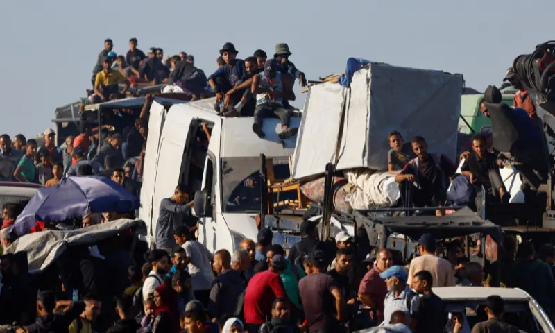 Palestinians, who were displaced to the southern part of Gaza at Israel&rsquo;s order, make their way along a road as they return to the north, amid a ceasefire between Israel and Hamas in Gaza, in the central Gaza Strip, on October 11, 2025. &mdash; Reuters