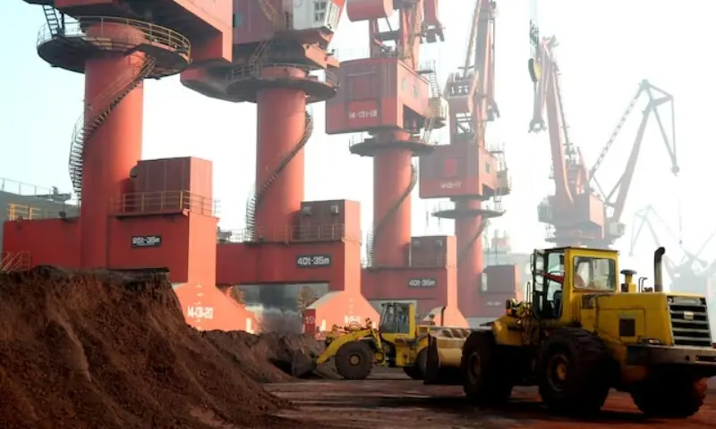 Workers transport soil containing rare earth elements for export at a port in Lianyungang, Jiangsu province, China October 31, 2010. Picture taken October 31, 2010. &mdash;Reuters