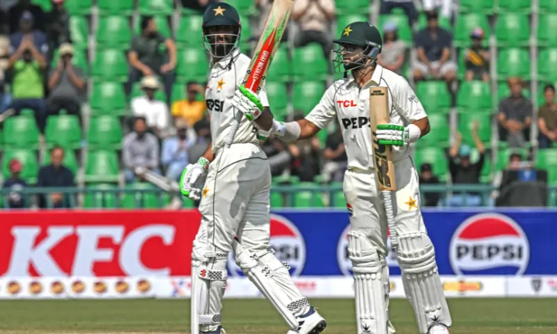 Pakistan&rsquo;s captain Shan Masood (L) celebrates after scoring half century (50 runs) as his teammate Imam-ul-Haq watches during the first day of the first Test cricket match between Pakistan and South Africa at the Gaddafi Stadium in Lahore on October 12, 2025. &mdash; AFP