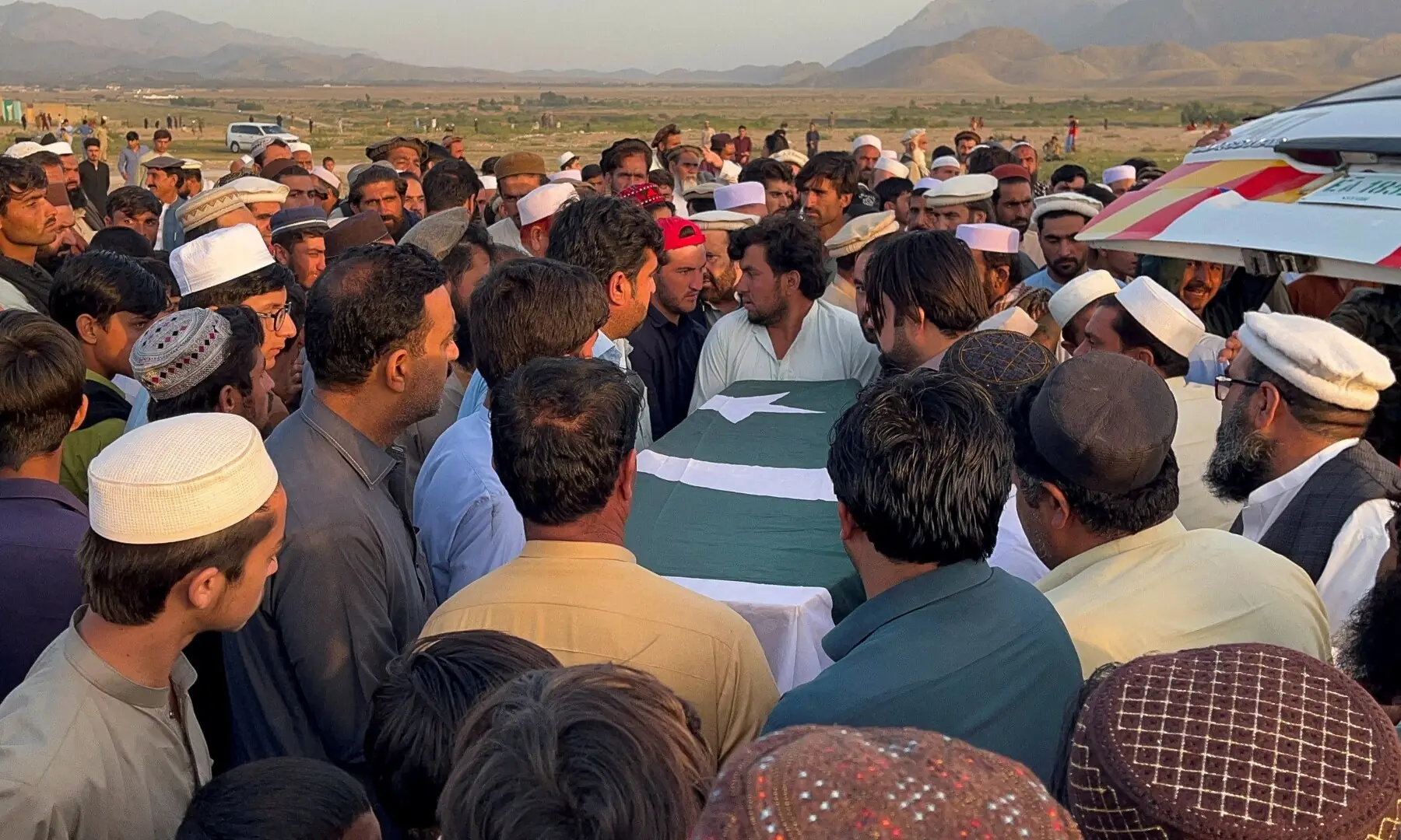 People carry a Pakistani flag-draped coffin of soldier Aslam Jadran, who died following the overnight border clashes between Pakistan and Afghanistan, during a funeral in Kurram, a tribal district of Khyber Pakhtunkhwa province, Pakistan October 12, 2025.