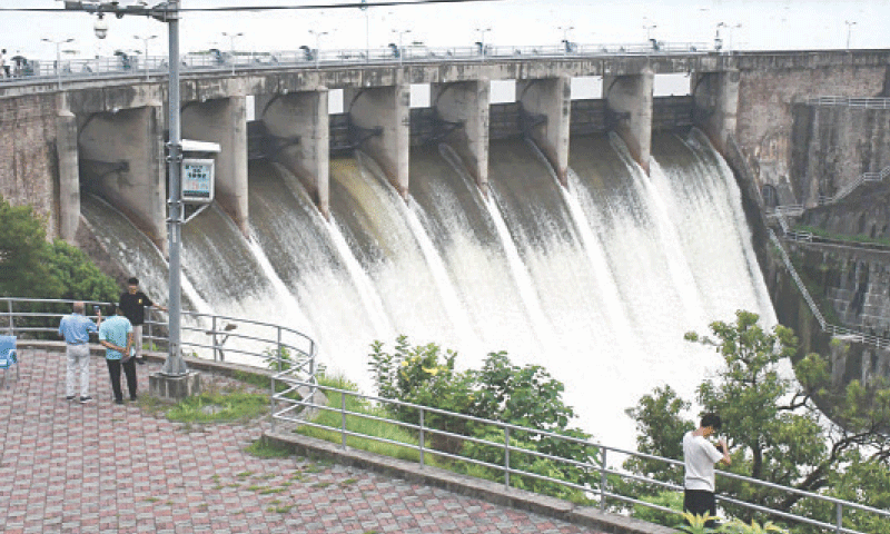 In this file photo, water gushes out of Rawal Dam after its spillways were opened on July 21. &mdash; Photo by Mohammad Asim/File