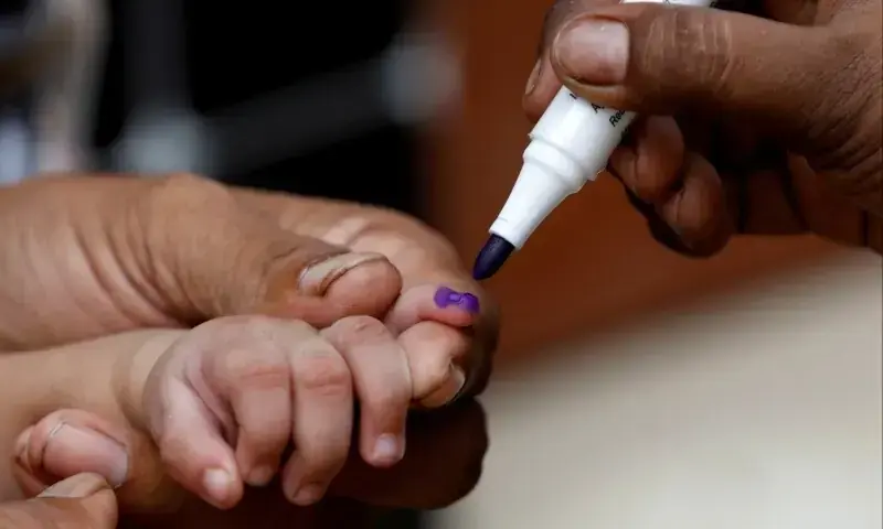 A boy gets his finger marked, after he is administered polio vaccine drops, during an anti-polio campaign in Karachi. &mdash; Reuters