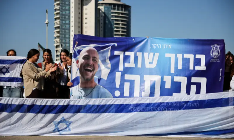 People gather while waiting for the arrival of hostages, who were kidnapped during the October 7, 2023 attack by Hamas and taken to Gaza, as they are released as part of a hostages-prisoners swap and a ceasefire deal in Gaza between Hamas and Israel, at the site of Beilinson Schneider complex, in Petah Tikva, Israel, on October 13. &mdash; Reuters