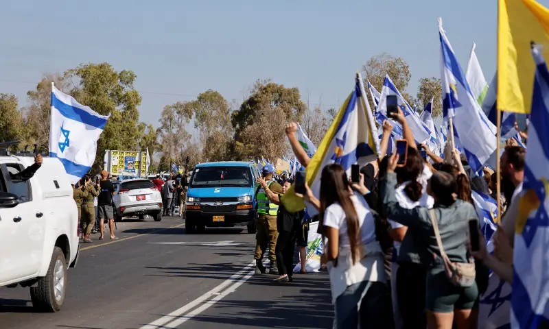 A convoy carrying released hostages, who have been held in Gaza since the October 7, 2023 attack by Hamas, as part of a prisoner-hostage swap and a ceasefire deal between Israel and Hamas, arrive in Reim, southern Israel, on October 13. &mdash; Reuters