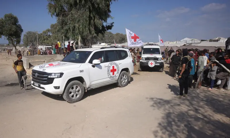 Palestinians gather on both sides of the road as International Red Cross vehicles arrive to transport the second batch of released Israeli hostages, south of Deir al-Balah in the central Gaza Strip on October 13, 2025. — AFP