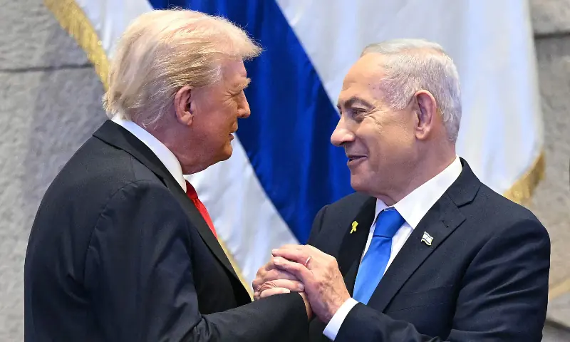 US President Donald Trump (L) holds hands and speaks with Israeli Prime Minister Benjamin Netanyahu at the Israeli parliament, the Knesset, in Jerusalem on October 13, 2025. — AFP