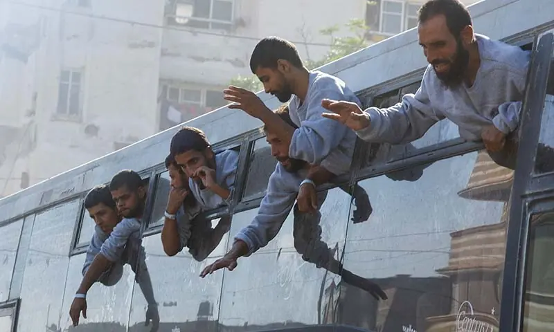Freed Palestinian prisoners look out of a bus after they were released by Israel as part of a captives-prisoners swap and a ceasefire deal between Hamas and Israel, in Khan Younis in the southern Gaza Strip on October 13. &mdash; Reuters