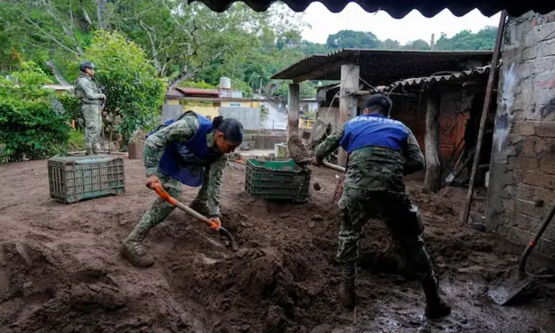 Members of the Mexican navy remove mud from the courtyard of a house as torrential rains from tropical storm Raymond triggered landslides and flooding in Jalcocotan, Nayarit state, Mexico, Oct 12. &mdash; Reuters