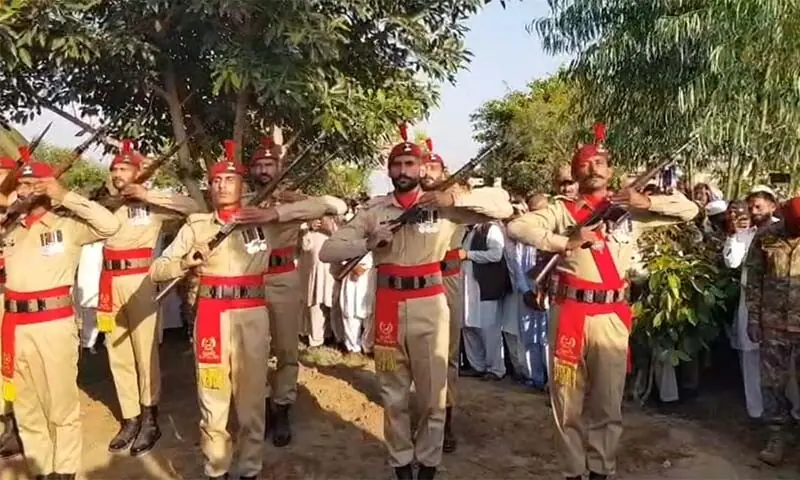 Soldiers perform a gun salute at the funeral of two soldiers in Gujar Khan on October 13. &mdash; Hamid Asghar