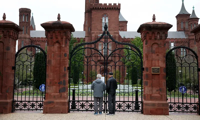Closed signage is seen at the fence surrounding the Smithsonian Institution Building on the National Mall in Washington, DC on October 12, 2025. Additional Smithsonian locations closed on Sunday due to a lapse in funding from the government shutdown. — AFP
