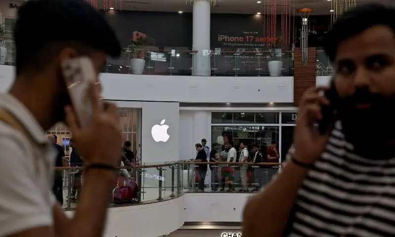 People wait in a queue outside an Apple retail store, as the iPhone 17 series goes on sale, in New Delhi, India on September 19. &mdash; Reuters/File