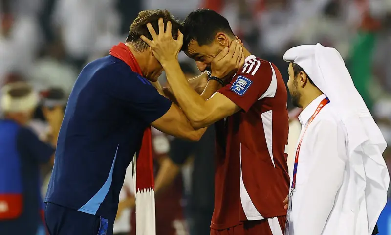 Qatar coach Julen Lopetegui celebrates with Boualem Khoukhi after qualifying for the FIFA World Cup at the Jassim Bin Hamad Stadium in Doha, Qatar on October 14, 2025. &mdash; Reuters