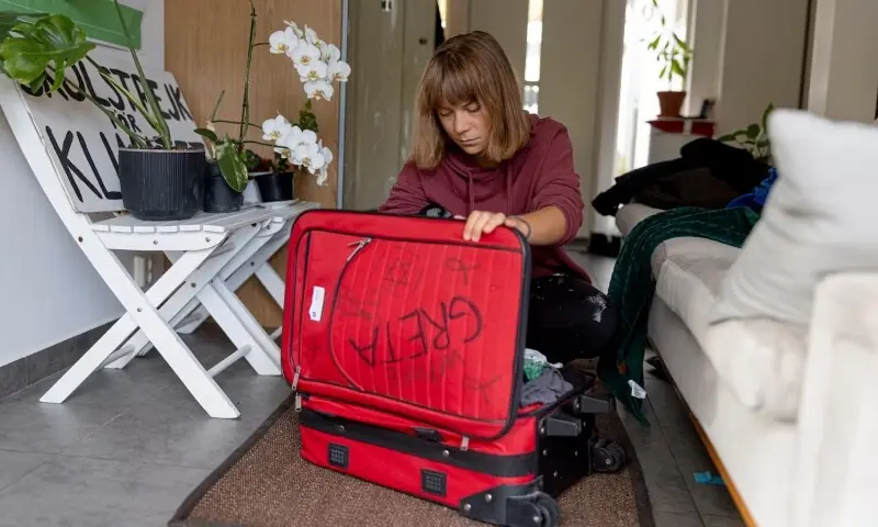 Greta Thunberg looks through her suitcase, which was confiscated by Israeli authorities who covered it in insulting messages. — Photo by Magnus Wennman/Aftonbladet