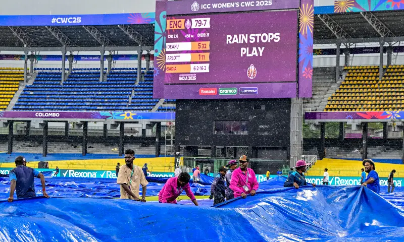 Groundsmen cover the field as rain halts play during the ICC Women’s Cricket World Cup 2025 one-day international (ODI) match between England and Pakistan at the R. Premadasa International Cricket Stadium in Colombo on October 15, 2025. — AFP