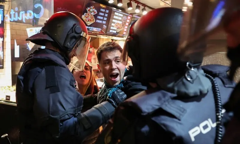 Police officers scuffle with a demonstrator during a general strike called by Spanish unions in solidarity with Palestinians in Gaza, in Madrid, Spain, on October 15. &mdash; Reuters