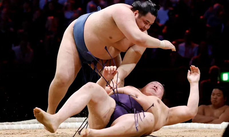 Onokatsu in action against Ichiyamamoto during the twelfth bout at the Grand Sumo Tournament - Royal Albert Hall in London, Britain on October 15, 2025. &mdash; Reuters
