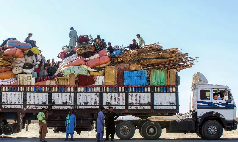 Afghan refugees en route to Afghanistan sit atop a halted truck with their belongings, as they await deportation at the Pakistan-Afghanistan border in Chaman on October 13, 2025, amid heavy border clashes between the two countries. &mdash; AFP