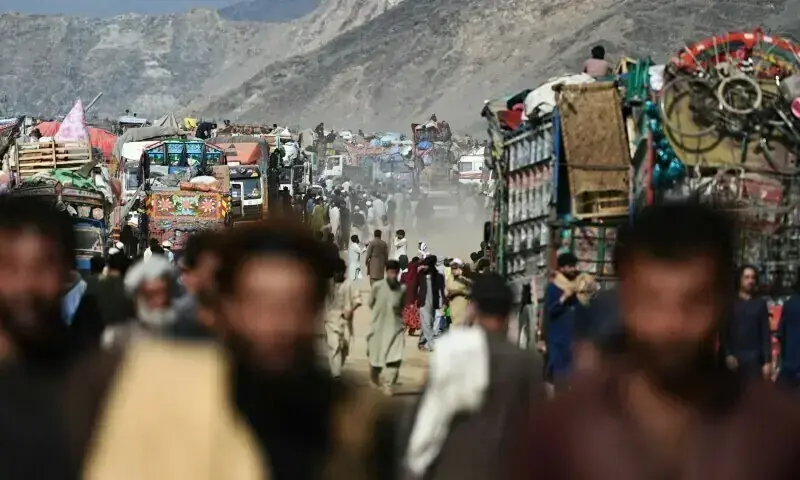 Afghan refugees gather at a makeshift camp upon their arrival from Pakistan, near the Afghanistan-Pakistan Torkham border. &mdash; AFP/File