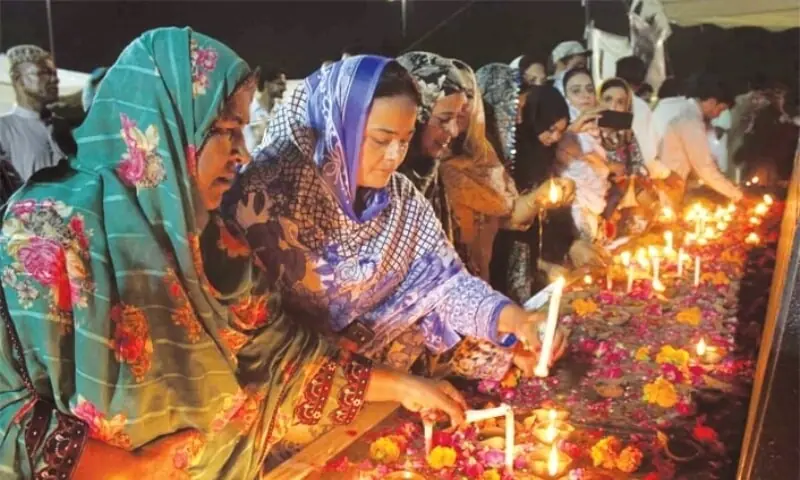 In this undated file photo, PPP activists hold a vigil at the site of the 2007 Karsaz blasts. &mdash; PPI/File