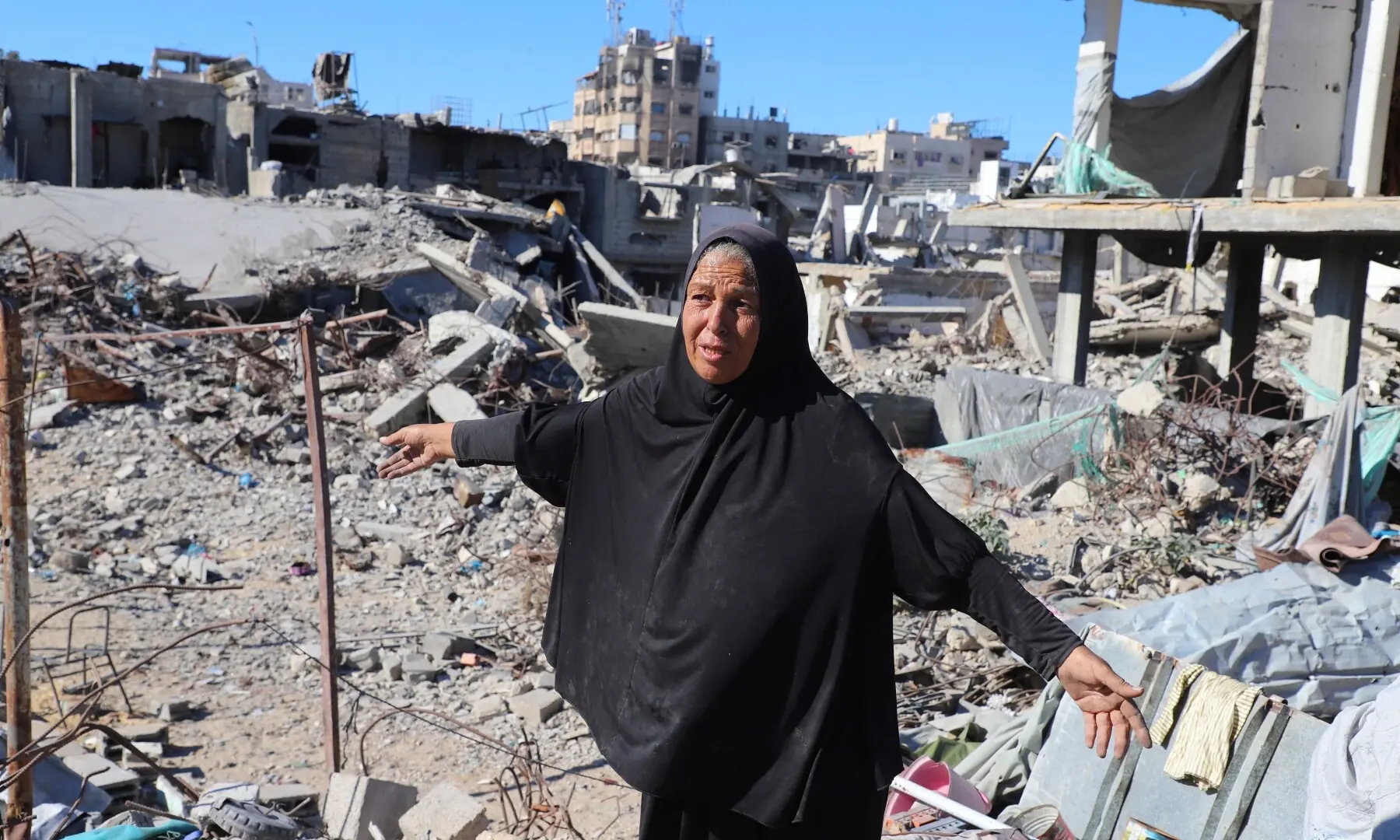 A Palestinian woman, Hayam Meqdad, 49, walks on the rubble of her destroyed home, as she now lives in a tent after getting displaced during the war, in Gaza City on October 15, 2025. — Reuters/Ebrahim Hajjaj