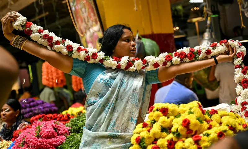 A vendor prepares a flower garland ahead of the Diwali celebrations, the Hindu festival of lights, at KR Market in Bengaluru, India on October 19, 2025. &mdash; AFP