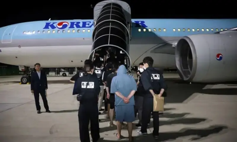 South Korean police officers escort South Korean nationals suspected of being involved in online scam operations, as they board a Korean Air aircraft at the Techo International Airport, Kandal province, Cambodia, October 18, 2025. &mdash; Reuters