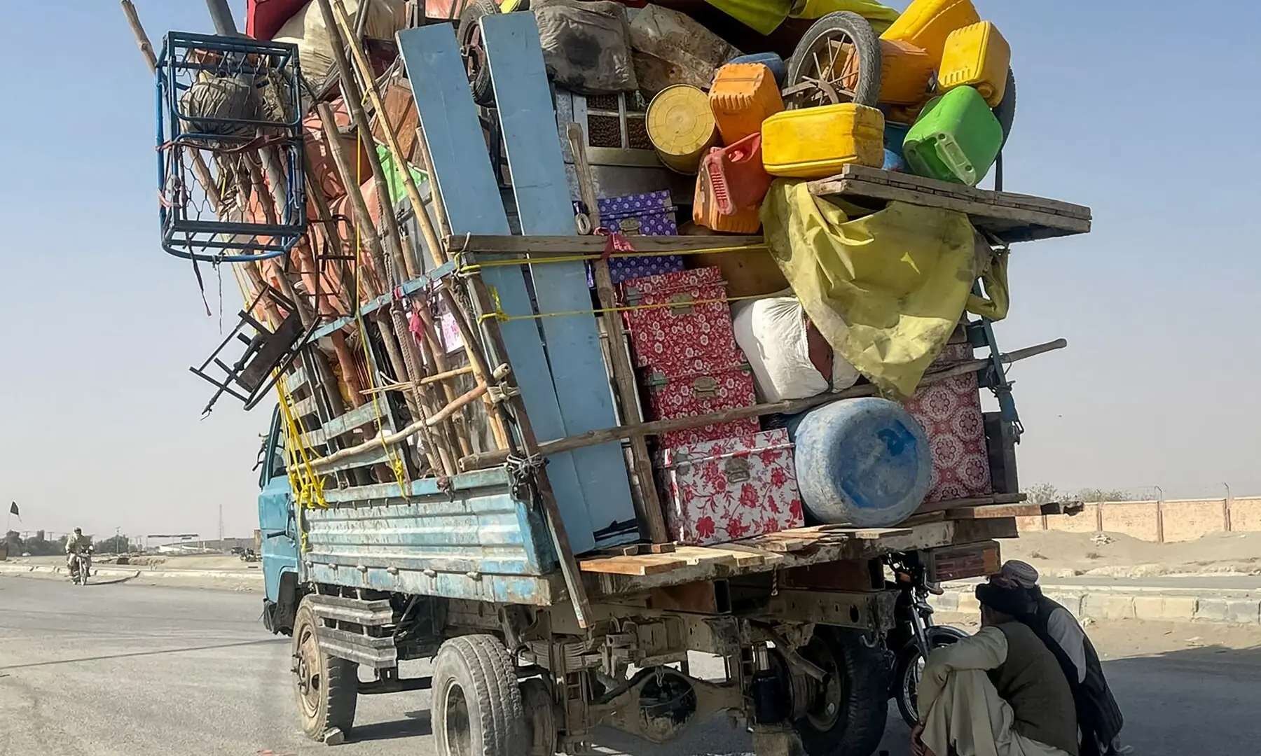  Afghan refugees sit beside a truck loaded with their belongings as they await deportation at the Pakistan-Afghanistan border in Chaman, Pakistan, October 19. &mdash; AFP 