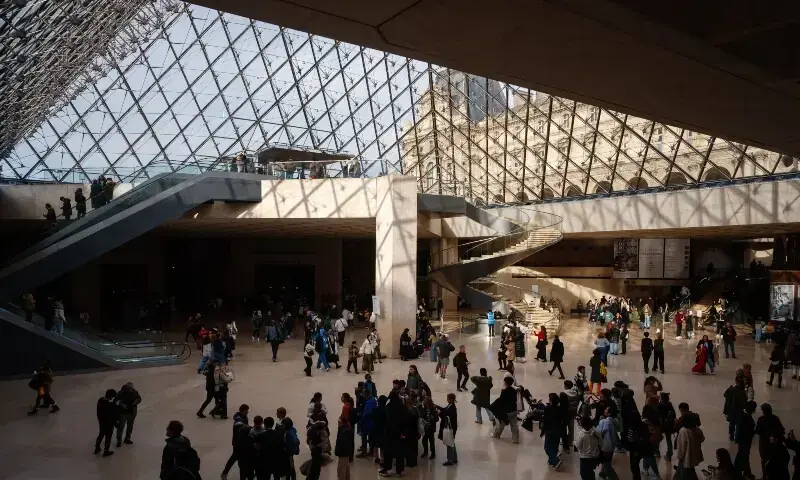 Visitors walk under the Louvre Pyramid designed by Ieoh Ming Pei at the Louvre Museum in Paris on January 23. β AFP Visitors walk under the Louvre Pyramid designed by Ieoh Ming Pei at the Louvre Museum in Paris on January 23. β AFP
