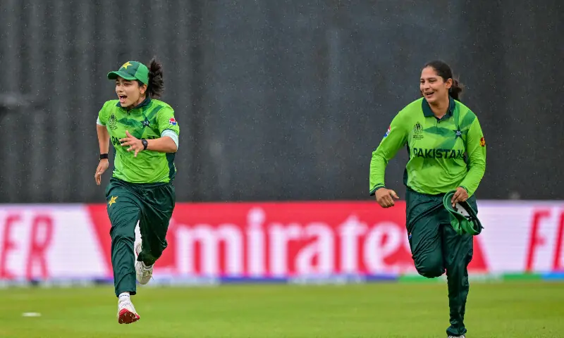 Pakistan&rsquo;s captain Fatima Sana (L) and her teammate Sadia Iqbal run off the field as rain stops play during the ICC Women&rsquo;s Cricket World Cup 2025 one-day international (ODI) match between Pakistan and South Africa at the R. Premadasa International Cricket Stadium in Colombo on October 21, 2025. &mdash; AFP