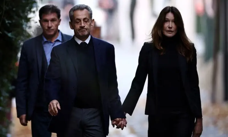Former French president Nicolas Sarkozy leaves his house with his wife Carla Bruni-Sarkozy on the day of his incarceration at the Sante prison to begin his five-year prison sentence for criminal conspiracy over attempts to raise campaign funds from Libya, in Paris, France, Oct 21. &mdash; Reuters