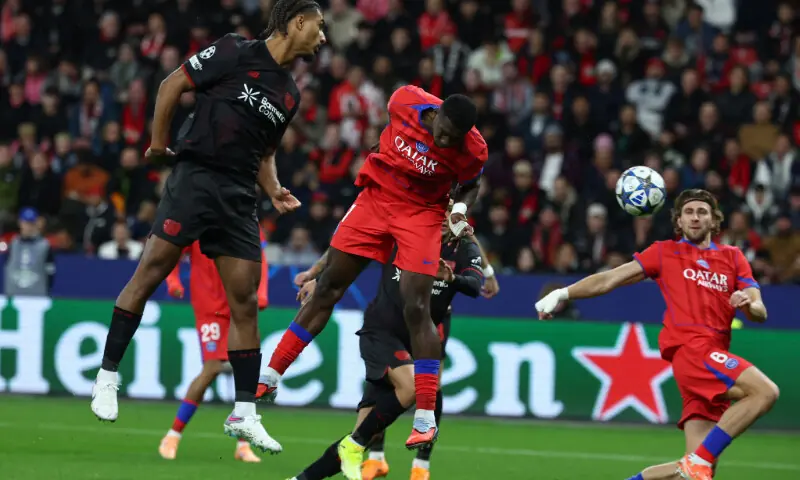 Paris Saint-Germain&rsquo;s Willian Pacho (C) heads to score during the UEFA Champions League match against Bayer Leverkusen at BayArena in Leverkusen on October 21, 2025.