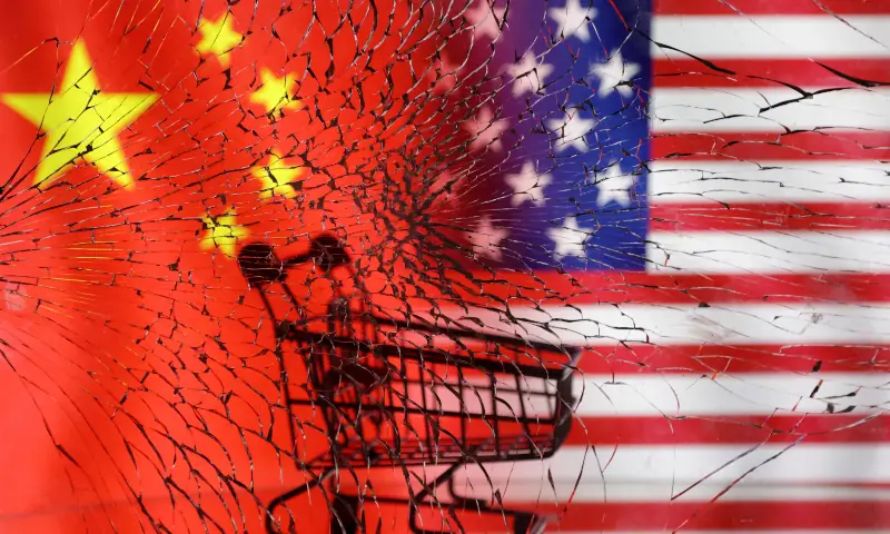 A shopping cart is seen through broken glass in front of the US and Chinese flags displayed in this illustration taken January 30, 2023. &mdash; Reuters/File