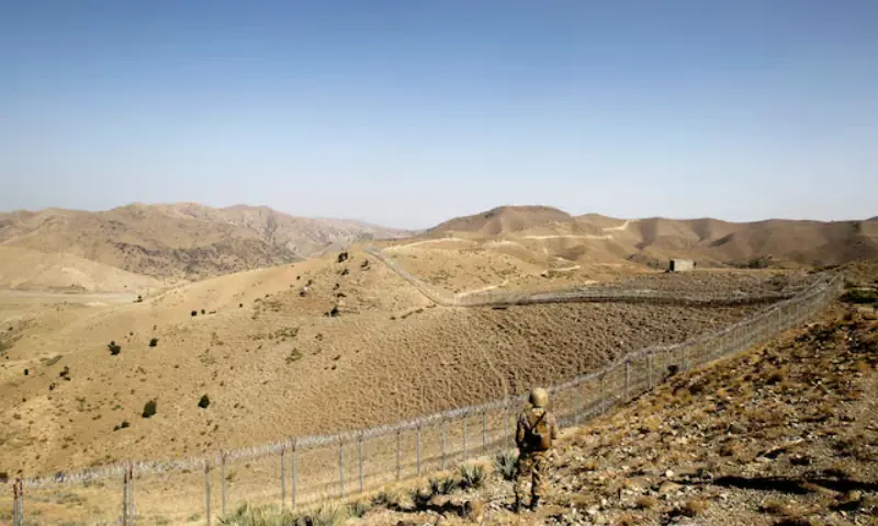 In this file photo, a Pakistani soldier stands guard along the border fence outside the Kitton outpost on the border with Afghanistan in North Waziristan on October 18, 2017. &mdash; Reuters/File