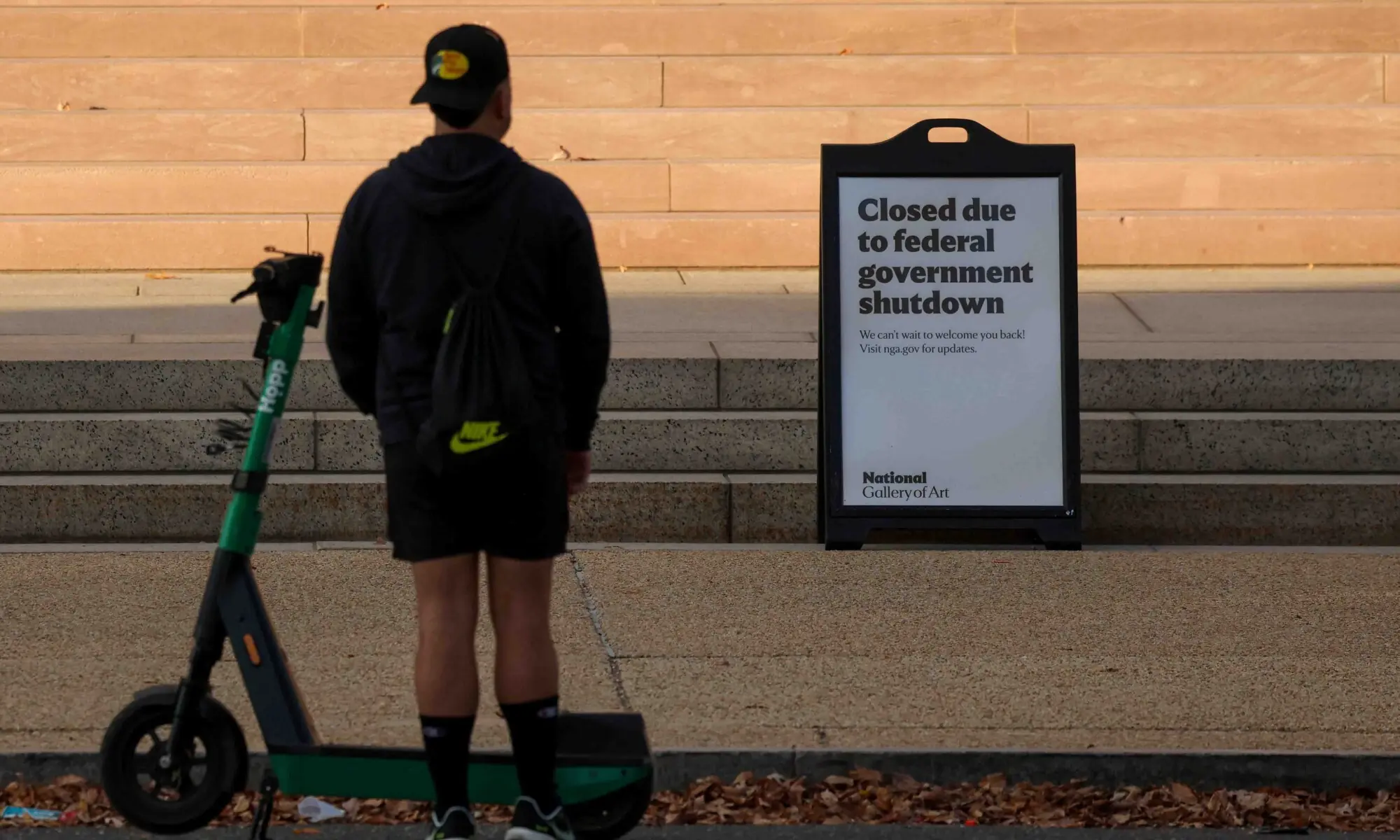 A man looks at a closed sign at the steps of the National Gallery of Art, weeks into the continuing US government shutdown, in Washington, DC, US on October 26. &mdash; Reuters