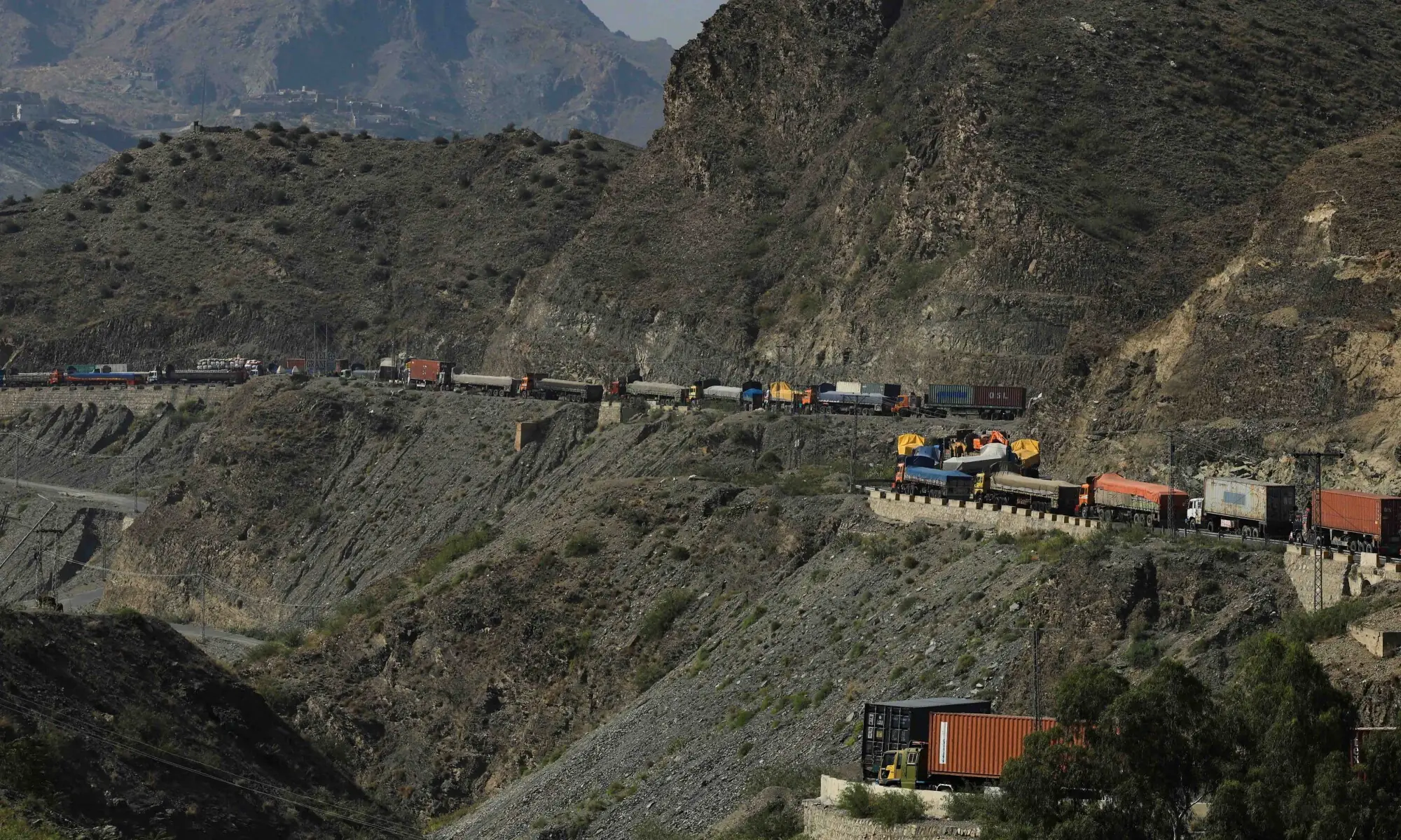 Trucks loaded with supplies park along a road leading to the Torkham border, after Pakistan closed border crossings with Afghanistan, following exchanges of fire between the two nations&rsquo; forces, in Torkham, Pakistan, October 15, 2025. &mdash; AFP