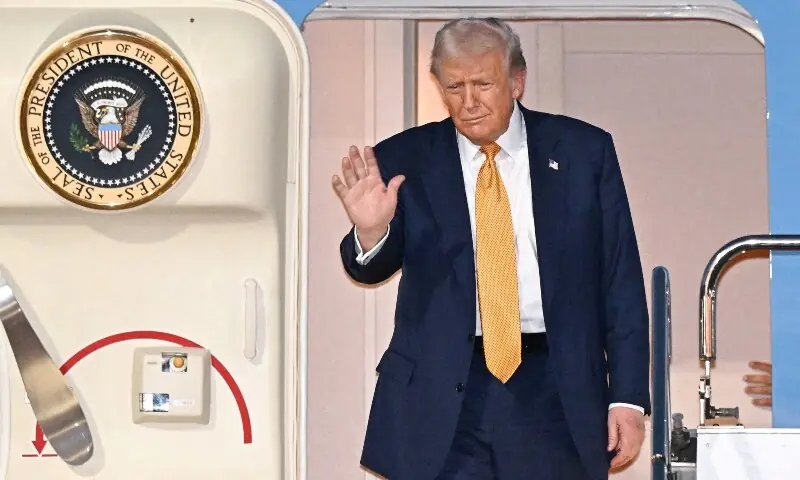 US President Donald Trump waves upon his arrival at Haneda airport in Tokyo, Japan, Oct 27. &mdash; Reuters