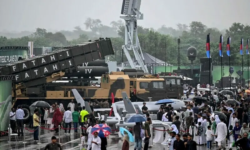 People look at unmanned combat aerial vehicles and the Fatah-I missile system on display at a military exhibition during Independence Day celebrations in Islamabad on August 14, 2025. &mdash; AFP