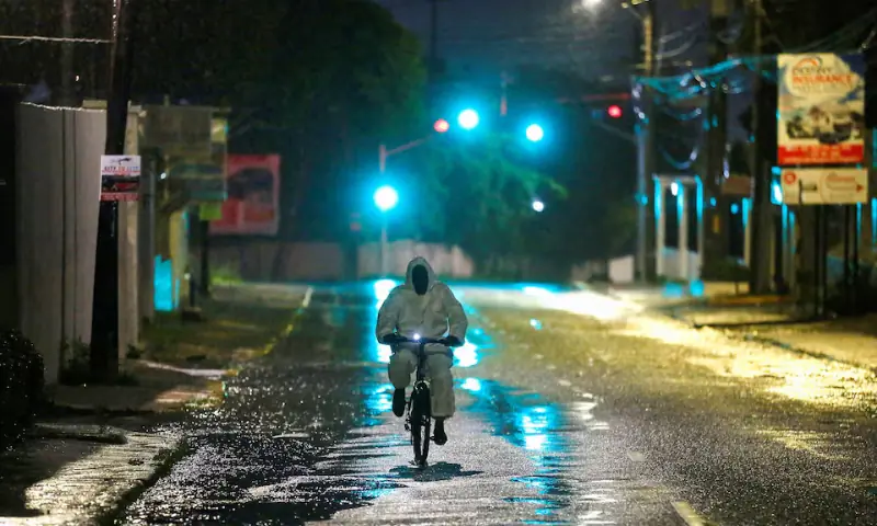 A man wearing a protective suit cycles on a street, as Hurricane Melissa approaches, in Kingston, Jamaica. — Reuters