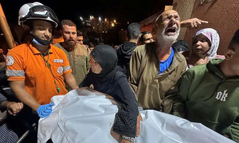 A Palestinian man reacts next to the body of a man, who according to medics was killed in an Israeli strike, at Nasser Hospital in Khan Younis, southern Gaza Strip on Oct 28, 2025. &mdash; Reuters