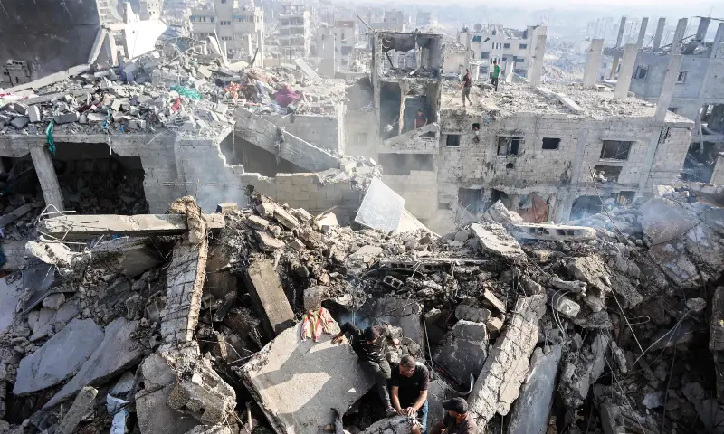 Palestinians try to recover a body from the rubble of a house destroyed in an overnight Israeli strike, in Gaza City, on Oct 29, 2025. — AFP Palestinians try to recover a body from the rubble of a house destroyed in an overnight Israeli strike, in Gaza City, on Oct 29, 2025. — AFP