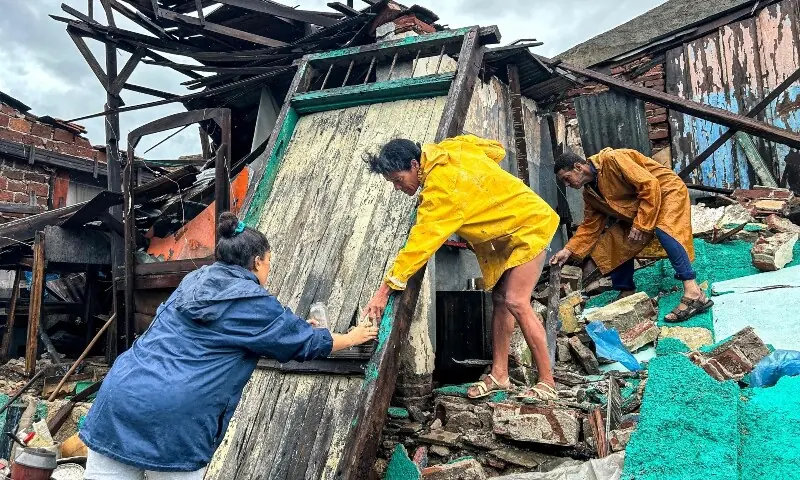 A family recovers their belongings from the rubble of their home after it collapsed during Hurricane Melissa in Santiago de Cuba, Cuba, on October 29. — AFP