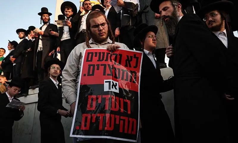 An ultra-Orthodox Jewish man holds a poster during a protest against conscription into Israel&rsquo;s military in Jerusalem, Israel, Oct 30. &mdash; AFP