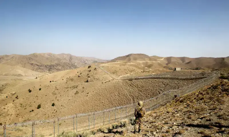 In this file photo, a Pakistani soldier stands guard along the border fence outside the Kitton outpost on the border with Afghanistan in North Waziristan on October 18, 2017. &mdash; Reuters/File