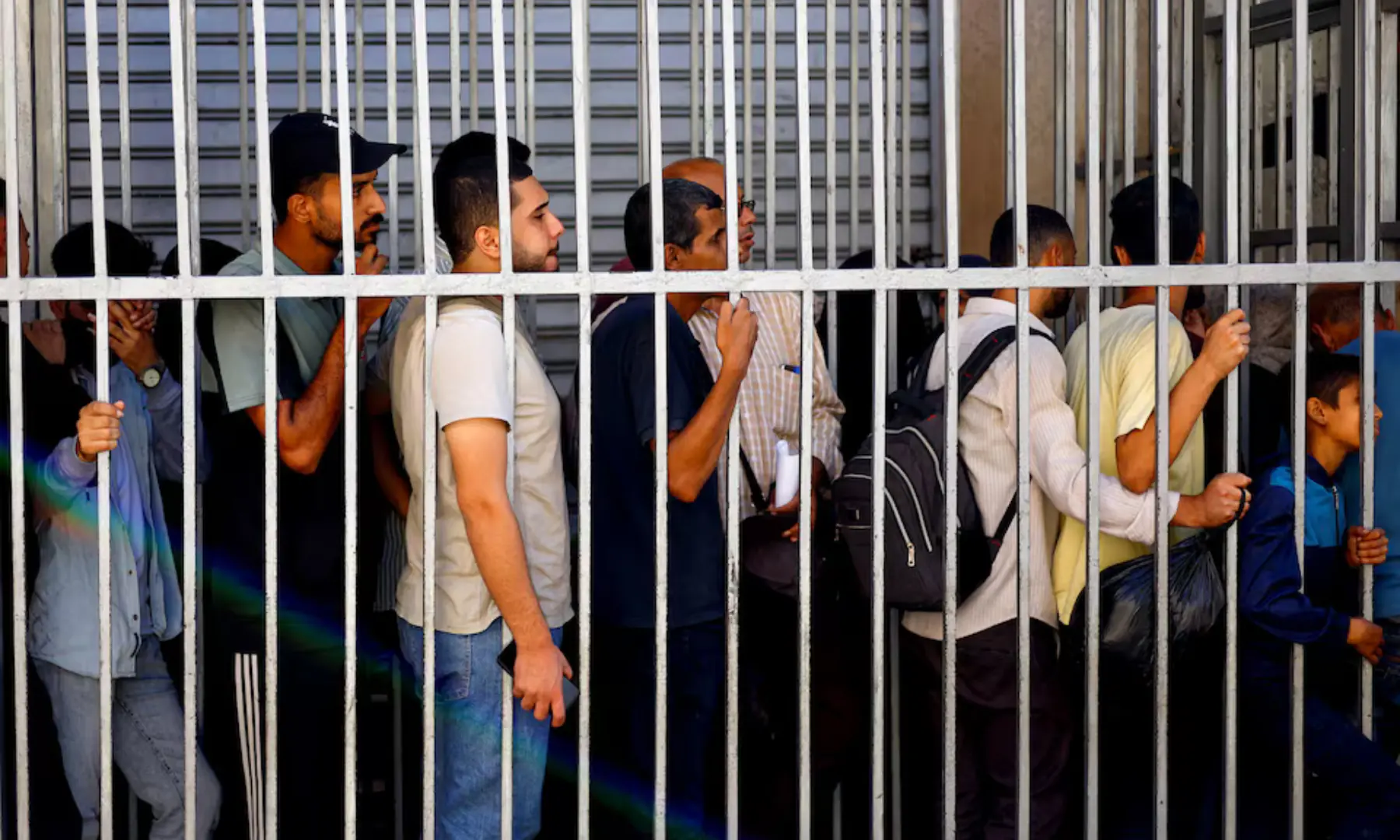 People queue outside the Bank of Palestine amid a cash shortage, in Nuseirat, central Gaza Strip on October 27, 2025. &mdash; Reuters